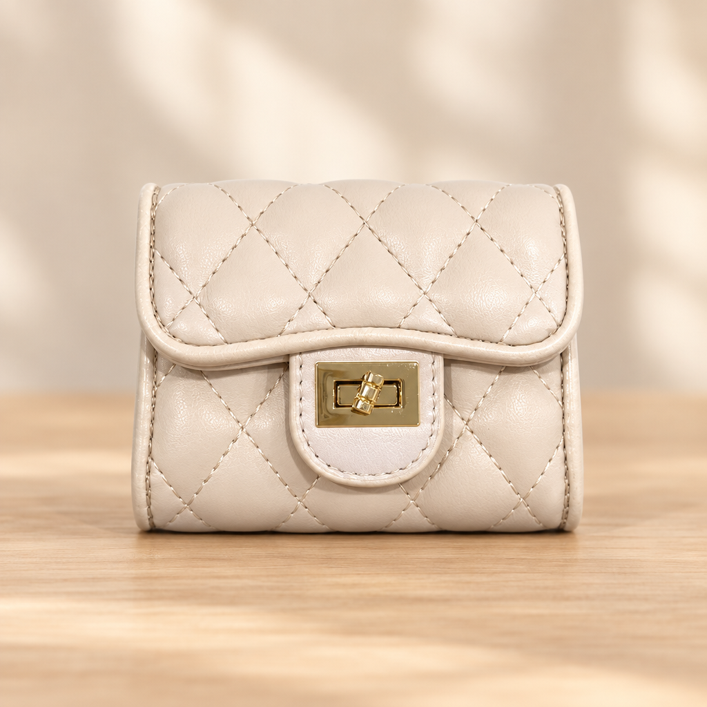 Beige quilted bag with gold clasp on a warm wooden table