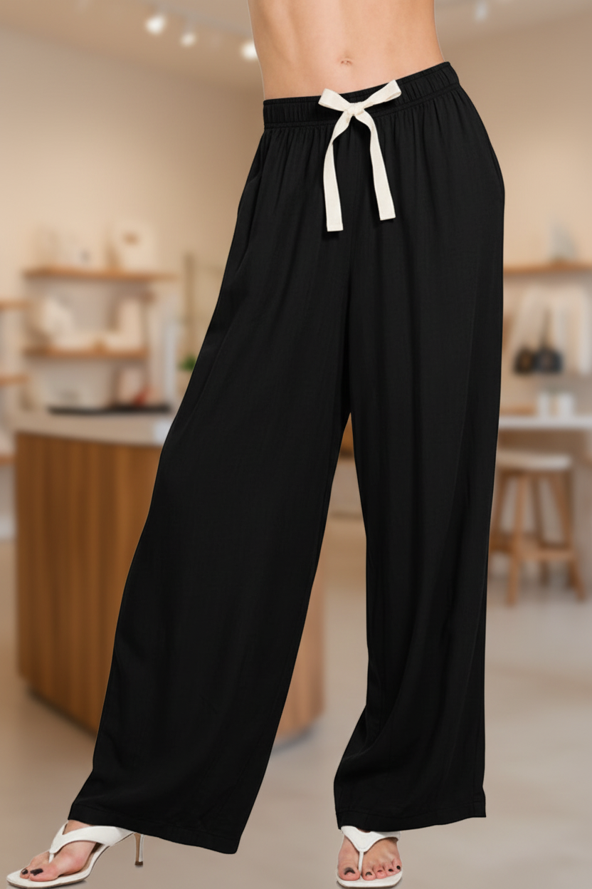 Black wide-leg pants in boutique setting