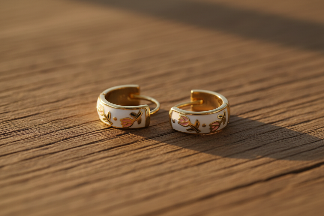 Gold hoop earrings on warm wood