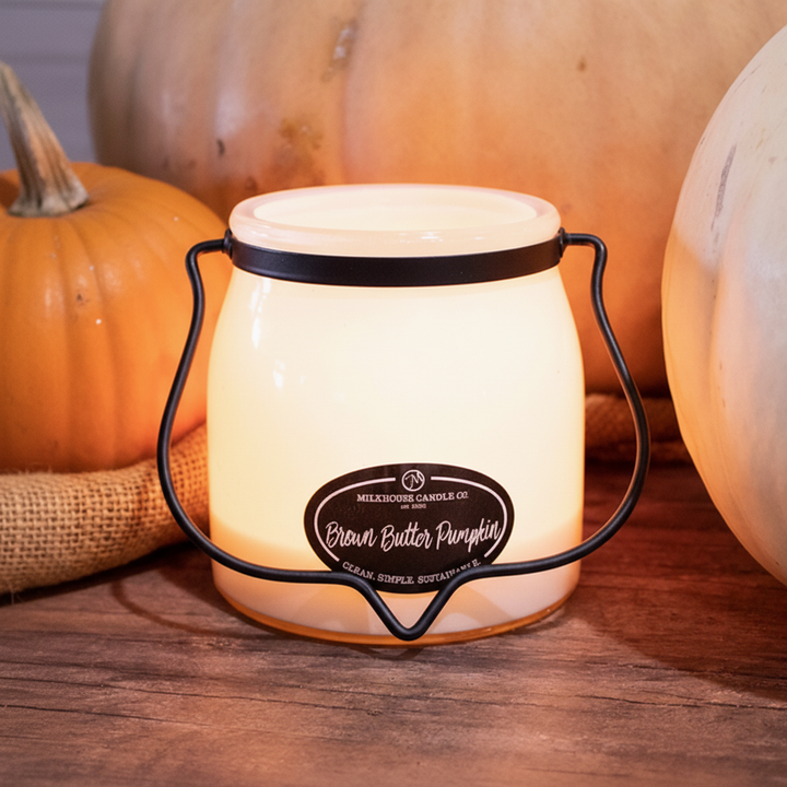 Milkhouse pumpkin spice 16oz butter jar candle on warm rustic wooden table lifestyle product photography