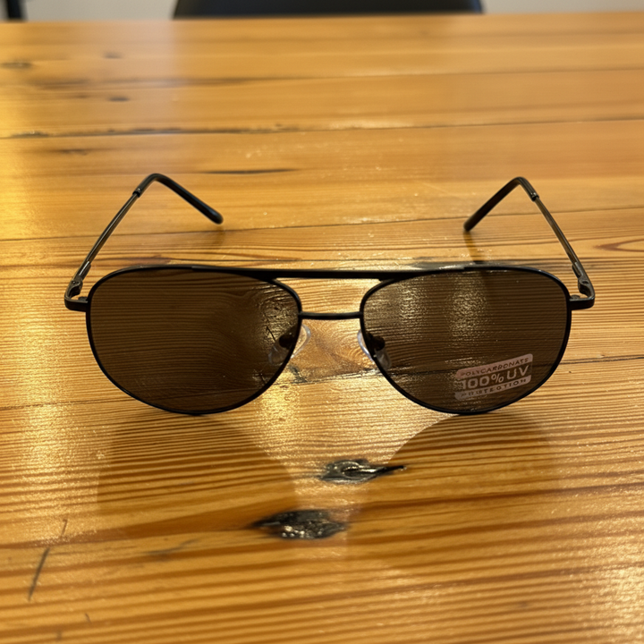 Sleek aviator sunglasses overhead view on wooden table – Elle &amp; Beck&