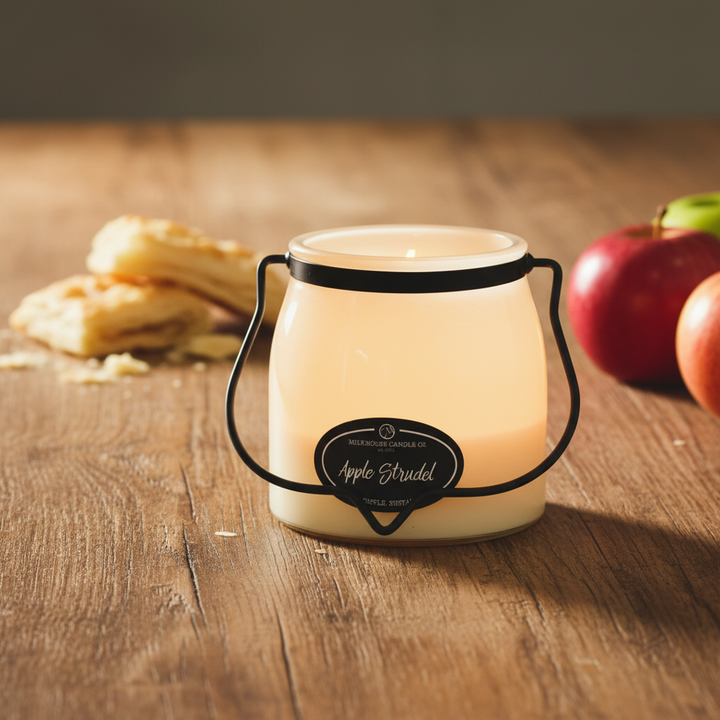 Milkhouse apple strudel 16oz butter jar candle on warm rustic wooden table lifestyle product photography