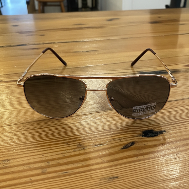 Gradient lens aviator sunglasses styled on wooden table – Elle &amp; Beck&