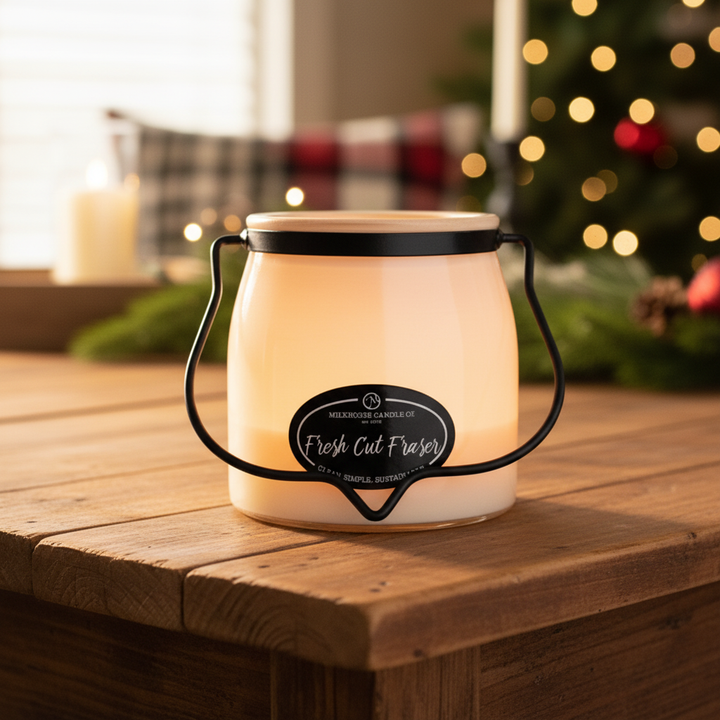 Milkhouse fresh cut Fraser Christmas tree 16oz butter jar candle on warm rustic wooden table lifestyle product photography