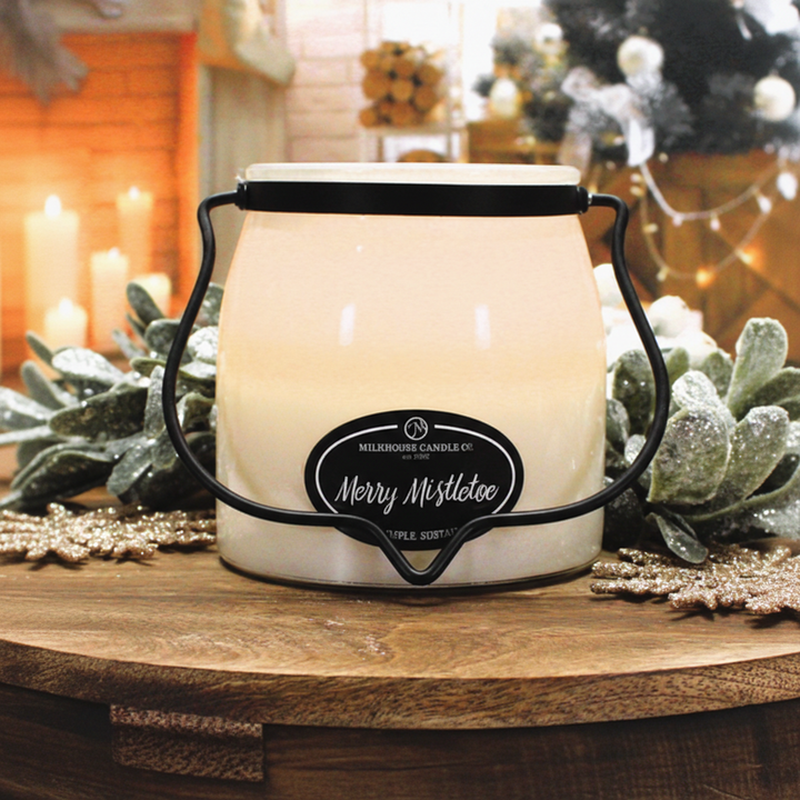 Milkhouse merry mistletoe 16oz butter jar candle on warm rustic wooden table lifestyle product photography