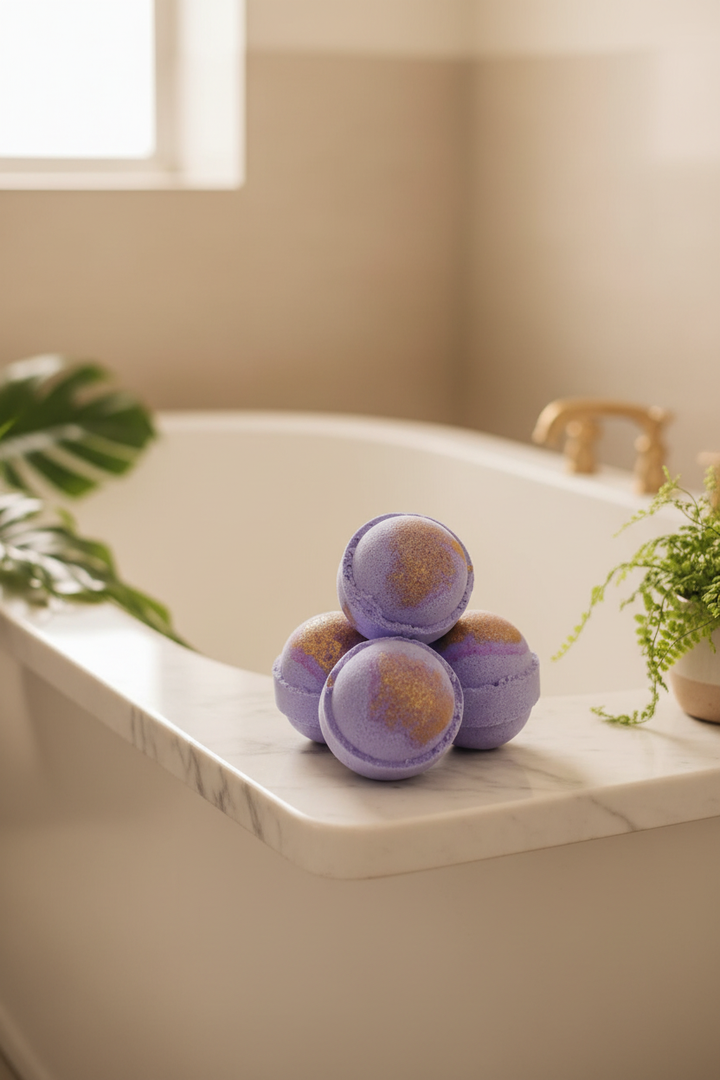 Purple and gold shimmer bath bombs near a bathtub with warm neutral spa tones