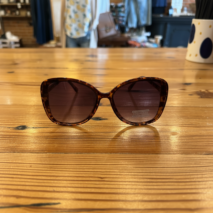 Oversized gradient sunglasses on wooden table