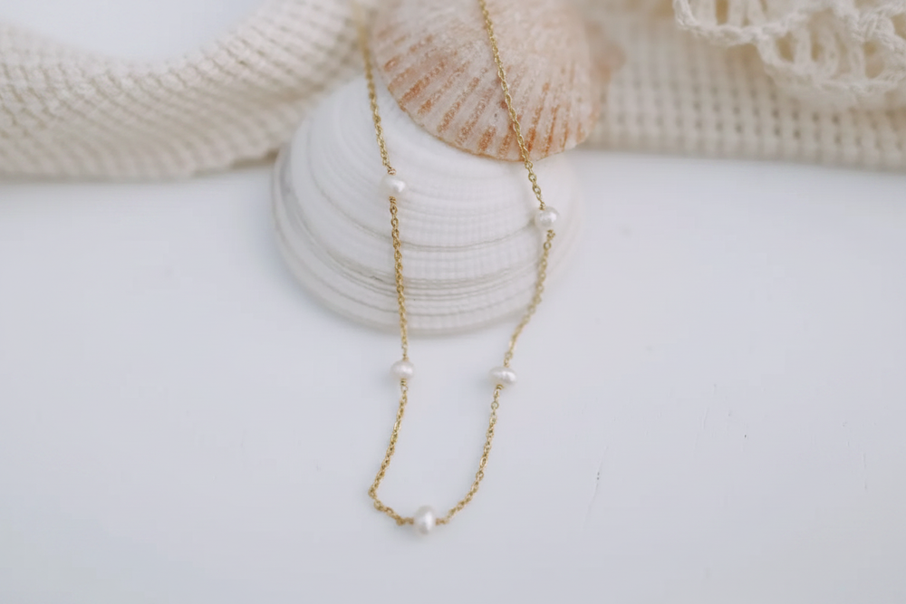 Pearl necklace flat lay enhanced