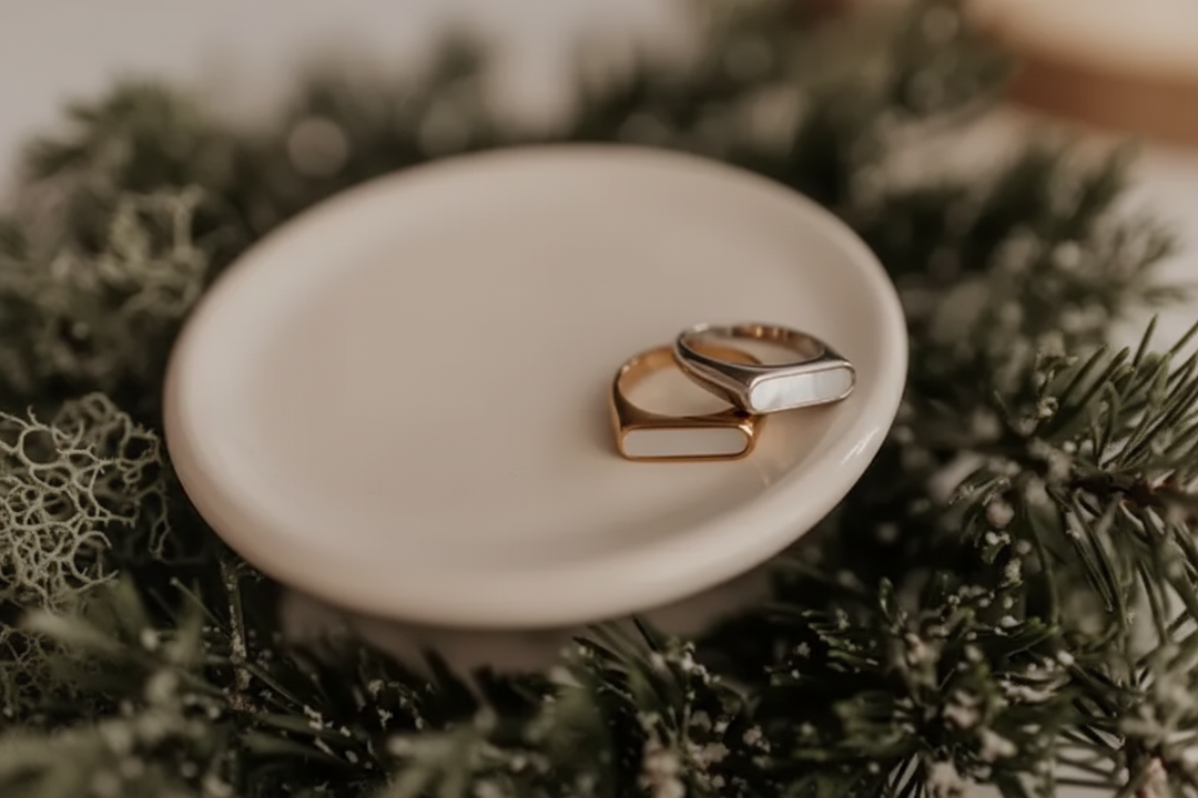 Stacked signet rings on dish
